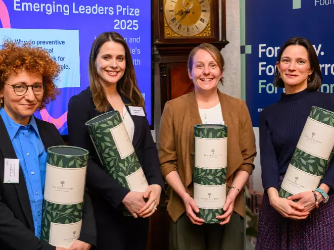 Four people receiving prizes